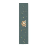 Nativity & Olive Christmas table runner shown flat, a nativity stable with gold stars and olive sprigs on deep green