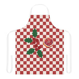 Blood orange check Christmas apron laid flat with white neck and waist straps, a red and cream checkerboard with holly and a cut blood orange