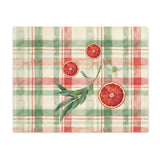 Blood Orange & Olive Plaid Christmas placemat, sliced blood oranges and an olive sprig on red and sage green plaid, on a wooden table