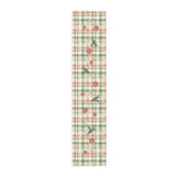 Blood Orange & Olive Plaid Christmas table runner, sliced blood oranges and an olive sprig on red and sage green plaid, on a laid dining table
