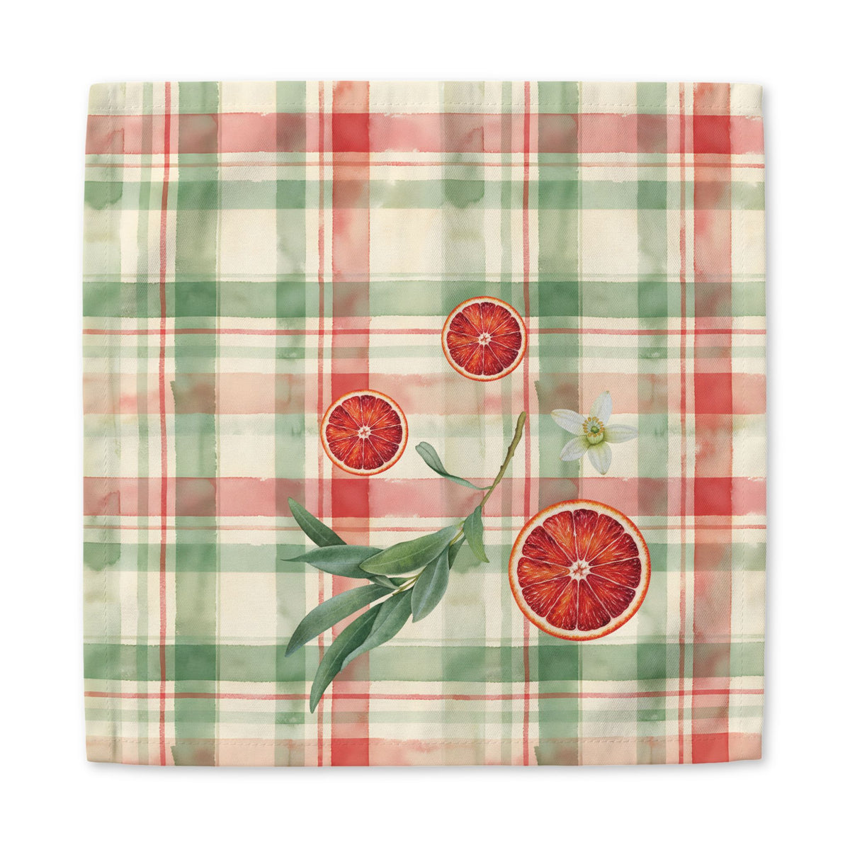 Blood Orange & Olive Plaid Christmas cloth napkin, an olive sprig and orange blossom on the plaid, at a laid place setting