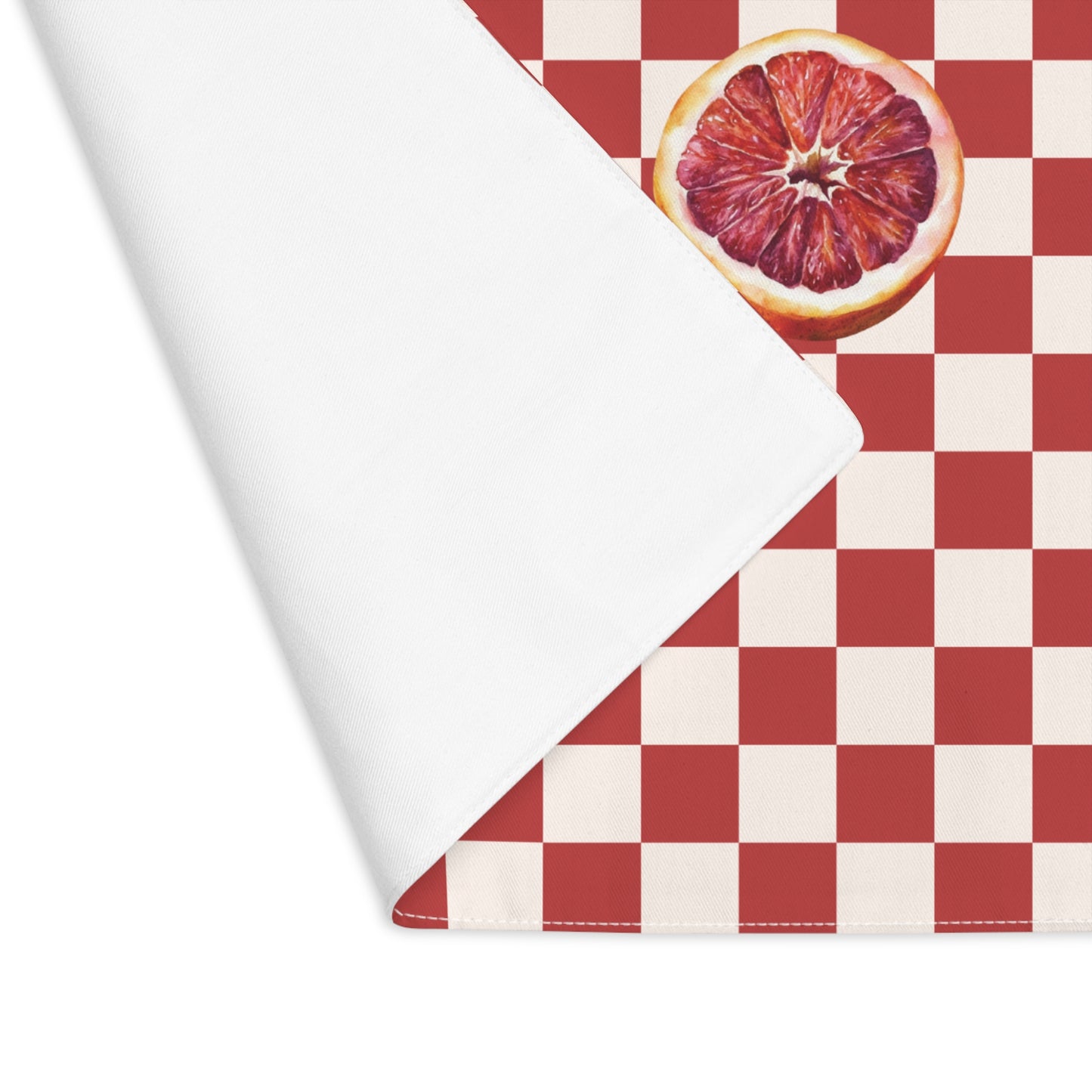 Blood orange check Christmas placemat laid flat, the check running out to the hemmed edge