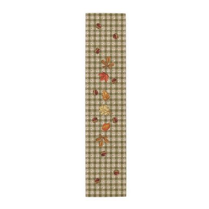 Chestnut & Mushroom fall table runner, mushrooms and acorns across a green check, on a wooden table