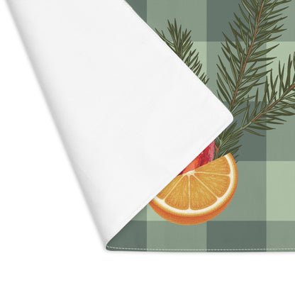 Pomegranate & Pine Gingham Christmas placemat, a pomegranate, pine cone, orange slice and gold star under a pine spray on a sage green gingham check