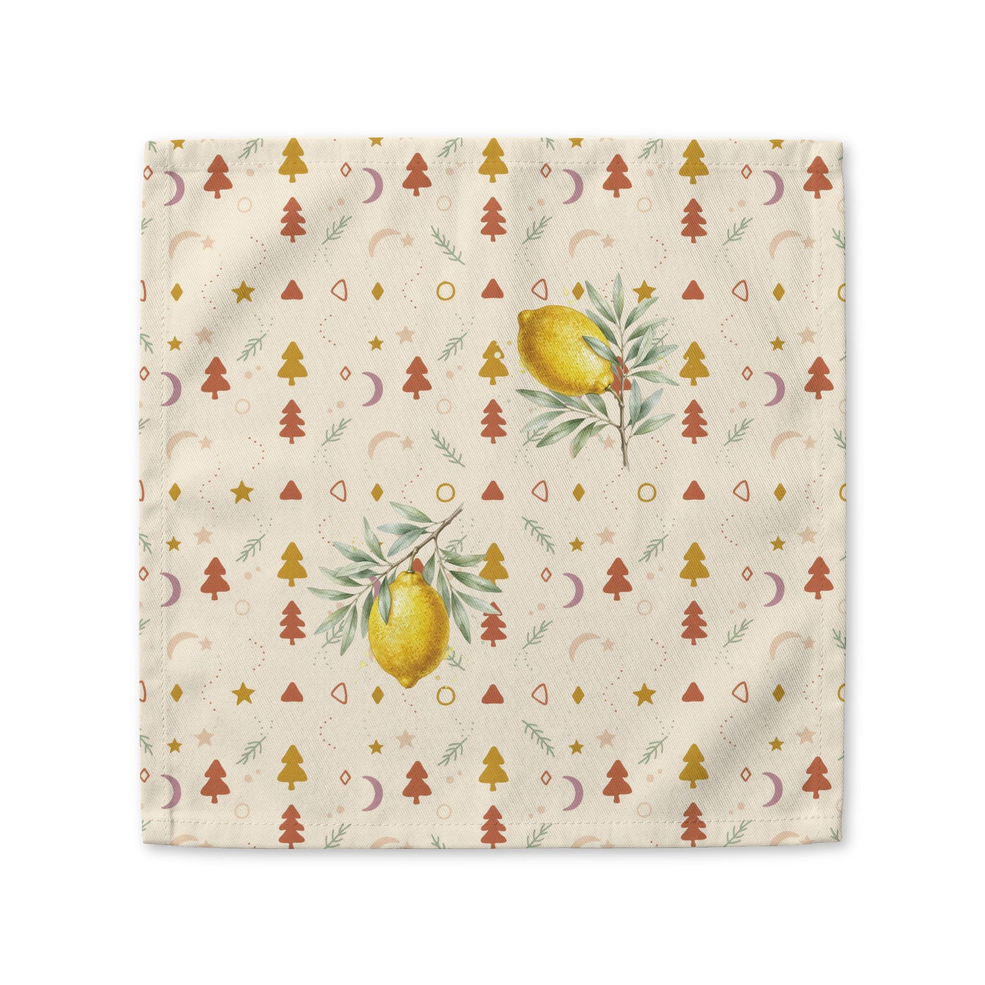 Lemon and pine Christmas cloth napkin laid flat, with watercolour lemons among small rust and gold Christmas trees, stars and crescent moons on cream