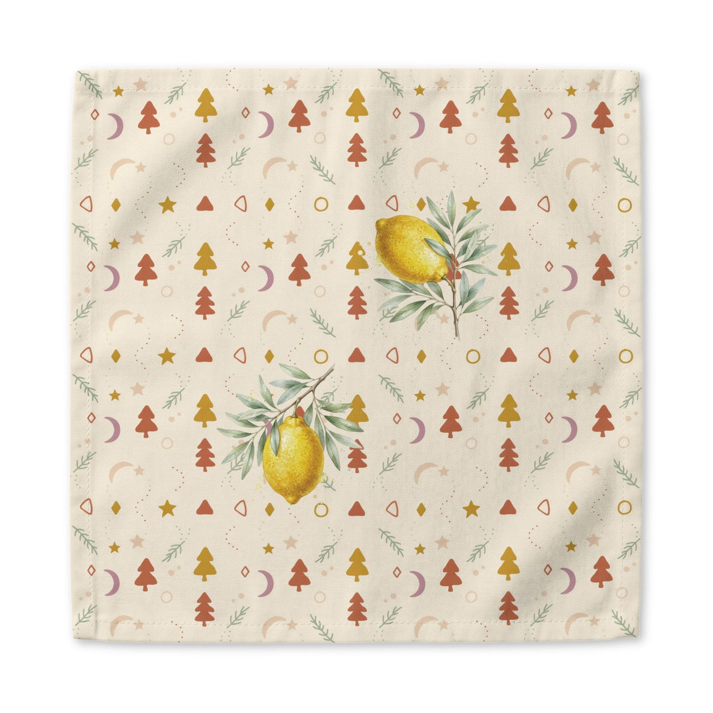Lemon and pine Christmas napkin laid flat, the print running out to the hemmed edge on the cream ground