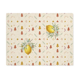 Lemon and pine Christmas placemat laid flat, with watercolour lemons among small rust and gold Christmas trees, stars and crescent moons on cream