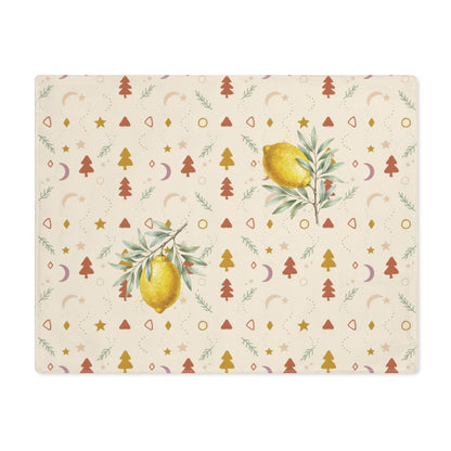 Lemon and pine Christmas placemat laid flat, with watercolour lemons among small rust and gold Christmas trees, stars and crescent moons on cream