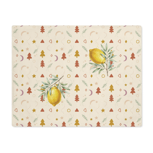 Lemon and pine Christmas placemat laid flat, with watercolour lemons among small rust and gold Christmas trees, stars and crescent moons on cream