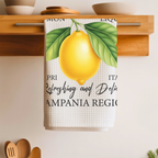 Limoncello tea towel folded over a wooden shelf rail above a kitchen counter