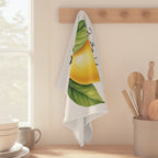 Limoncello tea towel hanging from a peg rail beside a window, with wooden utensils and stacked bowls