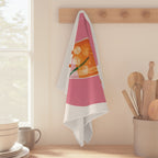 Aperitivo Spritz tea towel hanging from a peg rail beside a window, with wooden utensils and stacked bowls