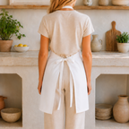 Apron seen from behind, showing the tie-back waist closure and adjustable neck strap