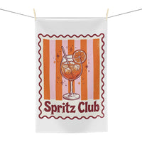 Spritz Club tea towel hanging, showing the orange striped panel with a spritz glass and Spritz Club lettering