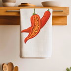 Chili Pepper tea towel folded over a wooden shelf rail above a kitchen counter