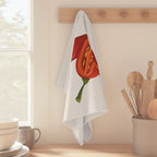 Chili Pepper tea towel hanging from a peg rail beside a window, with wooden utensils and stacked bowls