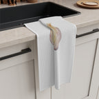 Garlic tea towel draped over the edge of a kitchen cabinet