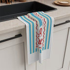 Limoncello Amore Mio tea towel draped over the edge of a kitchen cabinet