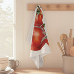 Tomato tea towel hanging from a peg rail beside a window, with wooden utensils and stacked bowls