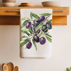 Olive Branch tea towel folded over a wooden shelf rail above a kitchen counter