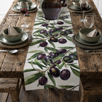 Olive Branch table runner on a dark weathered table with green plates and glasses