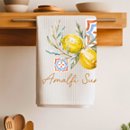 Amalfi Summer tea towel folded over a wooden shelf rail above a kitchen counter
