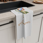 Amalfi Summer tea towel draped over the edge of a kitchen cabinet
