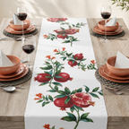 Pomegranate table runner on a laid table with wine glasses and plates
