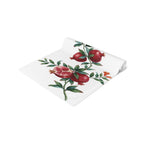 Pomegranate table runner folded, showing the pomegranate branch up close and the hemmed edge