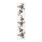 Pomegranate table runner in cotton twill, 16 by 72 inches, laid flat with repeating pomegranate branches and red blossom