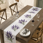 Lavender table runner on a rustic wooden table with white plates and cutlery
