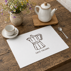 Caffè Italiano placemat on a wooden table with a stoneware cup and teapot and a jug of wildflowers