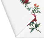 Pomegranate placemat with one corner turned back, showing the hemmed edge and the plain reverse