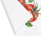 Tomato placemat with one corner turned back, showing the hemmed edge and the plain reverse