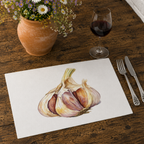 Garlic placemat on a wooden table with cutlery, a glass of red wine and a terracotta jug of daisies