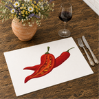 Chili Pepper placemat on a wooden table with cutlery, a glass of red wine and a terracotta jug of daisies
