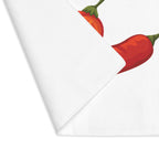 Chili Pepper placemat with one corner turned back, showing the hemmed edge and the plain reverse