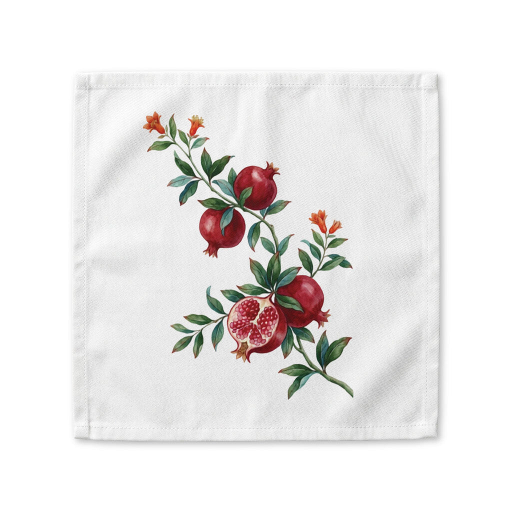 Pomegranate cloth napkin laid flat, a watercolor branch with fruit and orange blossom running corner to corner