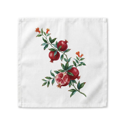 Pomegranate cloth napkin laid flat, a watercolor branch with fruit and orange blossom running corner to corner