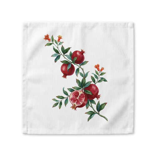 Pomegranate cloth napkin laid flat, a watercolor branch with fruit and orange blossom running corner to corner