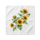 Sunflower cloth napkin laid flat, showing a watercolor bouquet of sunflowers with buds and broad green leaves
