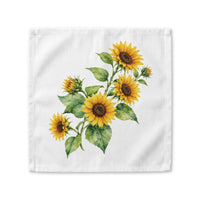 Sunflower cloth napkin laid flat, showing a watercolor bouquet of sunflowers with buds and broad green leaves