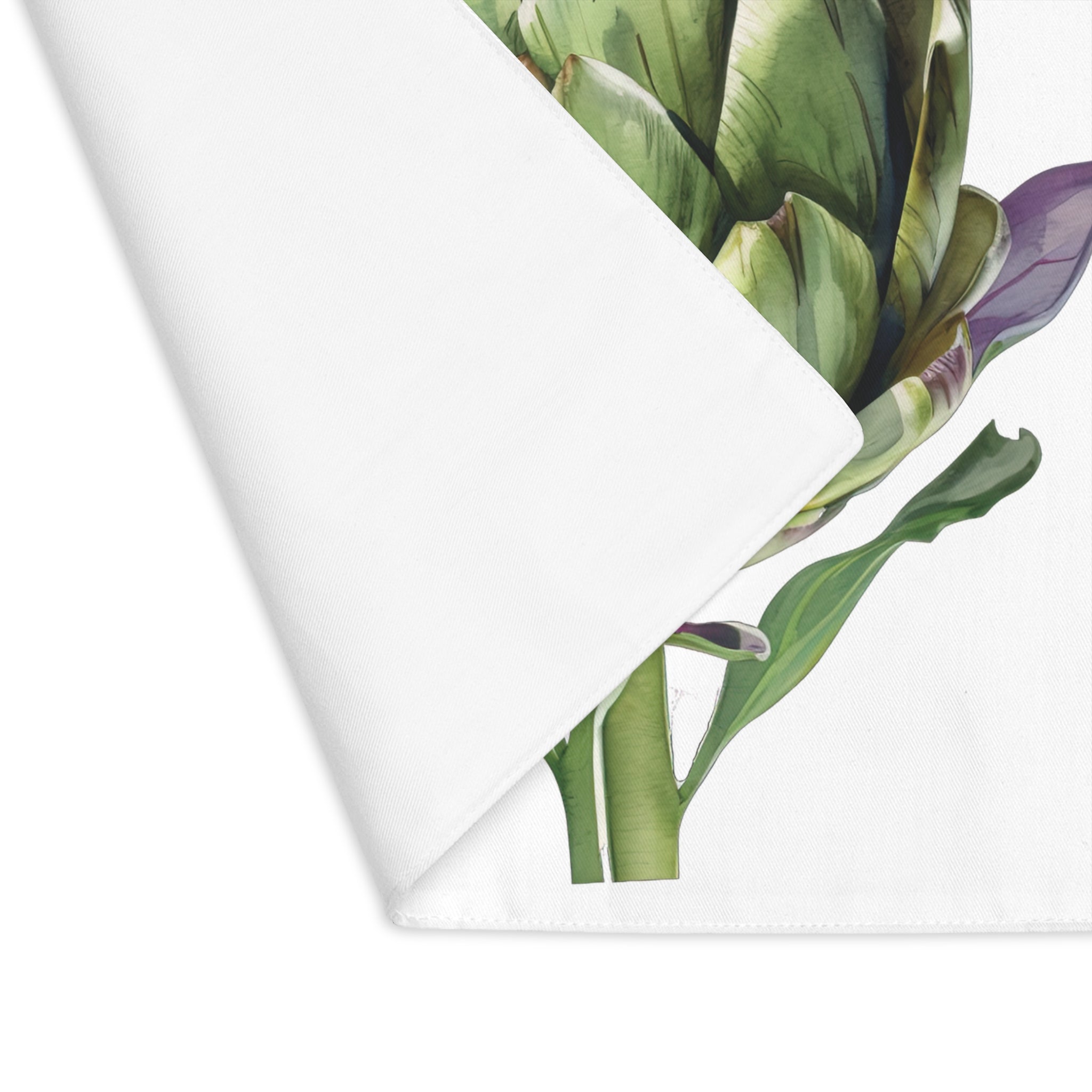 Artichoke placemat with one corner turned back, showing the hemmed edge and the plain reverse