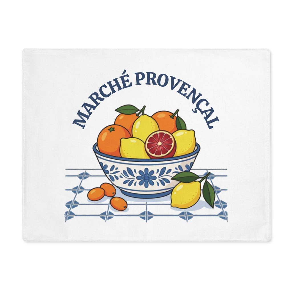 Marché Provençal placemat laid flat, showing a blue and white bowl of oranges and lemons with the market name arched above
