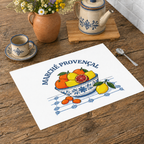 Marché Provençal placemat on a wooden table with a jug, a cup and a terracotta pot of yellow flowers