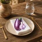 Eggplant and Garlic napkin on a cream plate with a glass of water and a terracotta vase of Mediterranean wildflowers