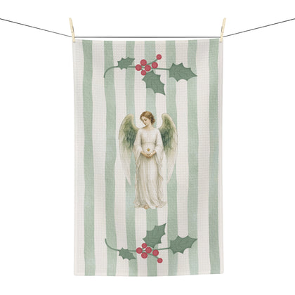 Angels and holly Christmas tea towel on a washing line, shown flat with the angel and red-berried holly on a soft green stripe