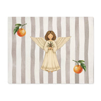 Angels and oranges Christmas placemat laid flat, with the angel and pine sprig on a soft grey stripe and an orange above and below