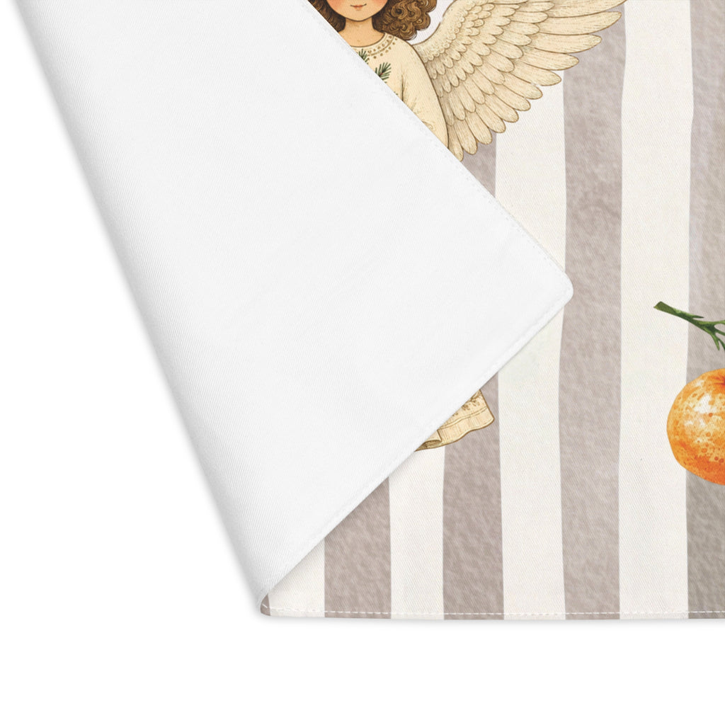 Corner of the Angels and oranges placemat folded back, showing the stitched hem and the plain white reverse
