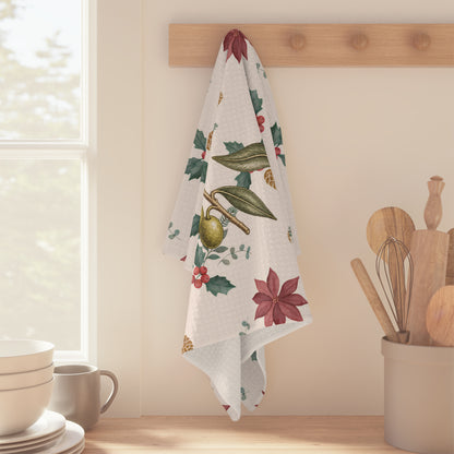 Waffle weave kitchen towel hanging from a peg rail beside a sunlit kitchen window